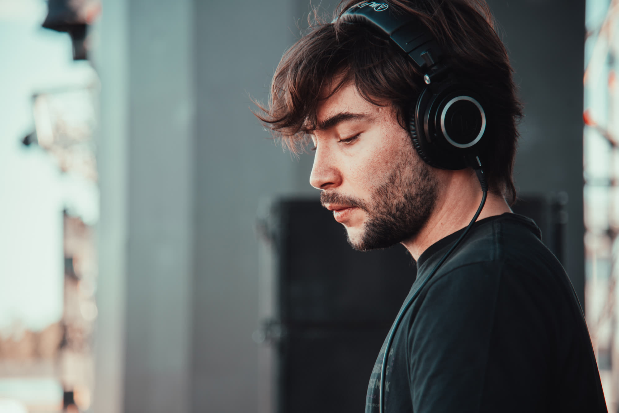 Joan Retamero in headphones, looking down